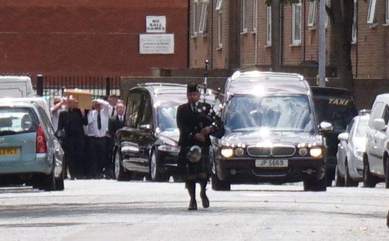 Bagpiper leading funeral 768x476
